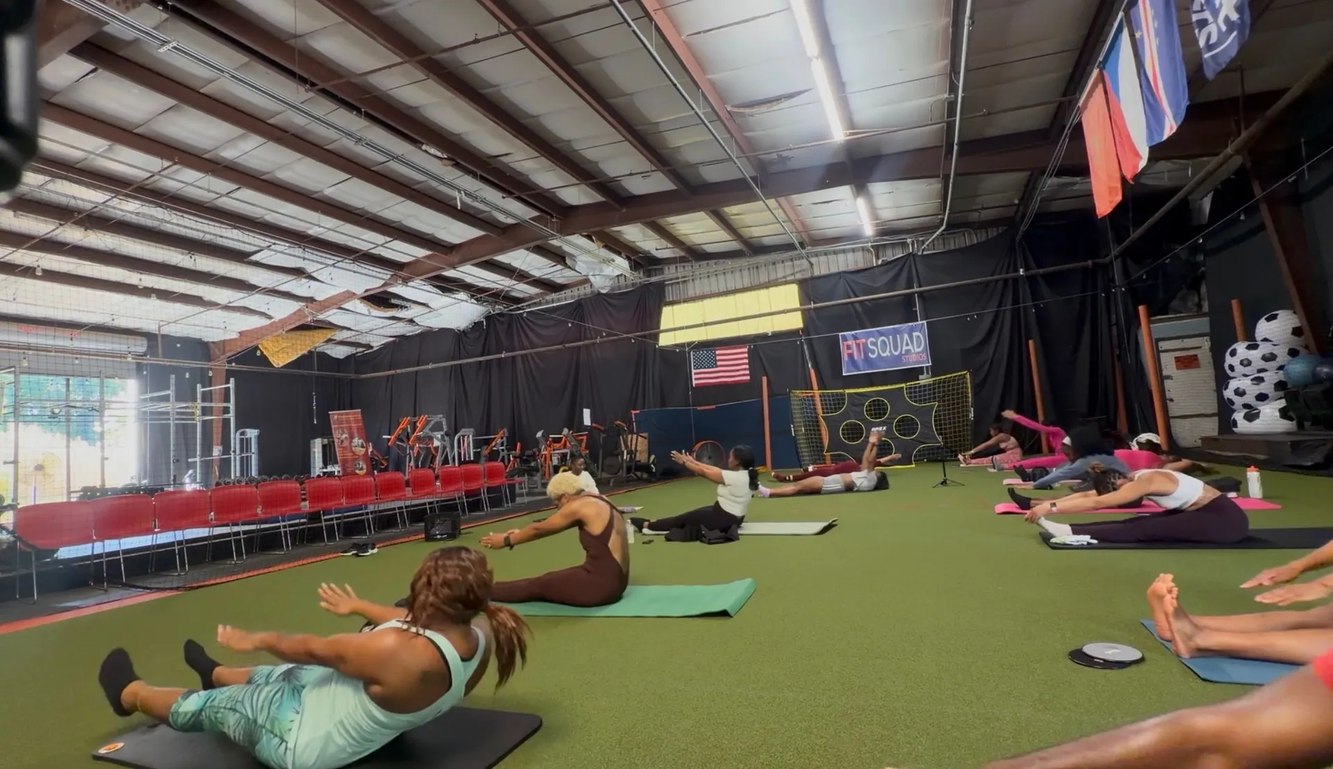 FitSquad members taking part in a group stretch and wellness class at the studio