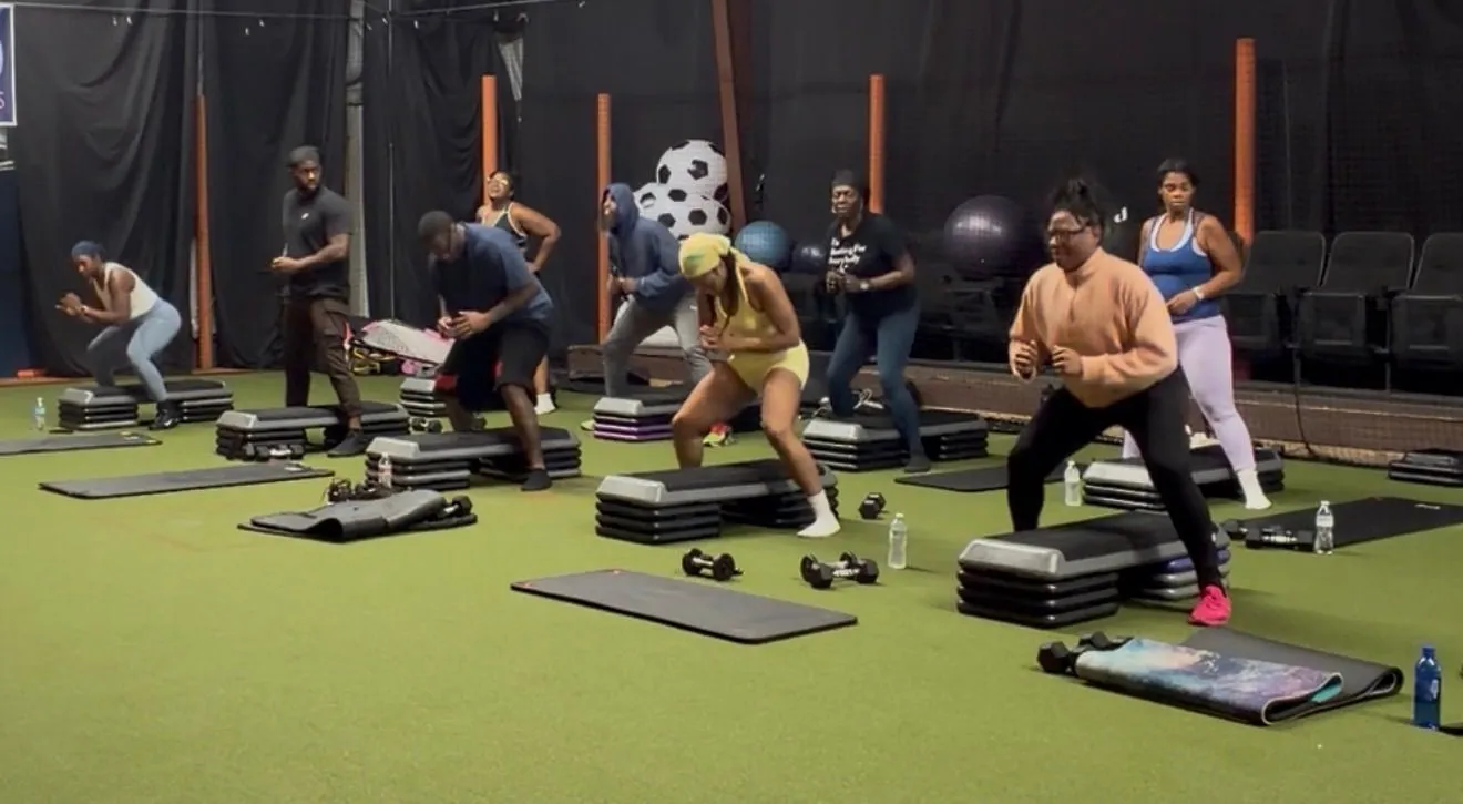 FitSquad members taking part in an indoor boot camp class with step platforms